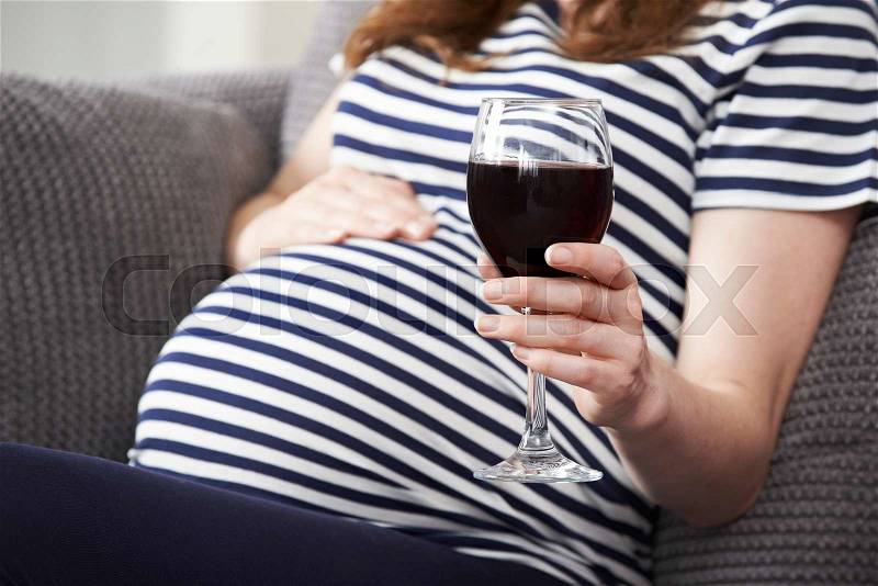 Close Up Of Pregnant Woman Drinking Red Wine, stock photo