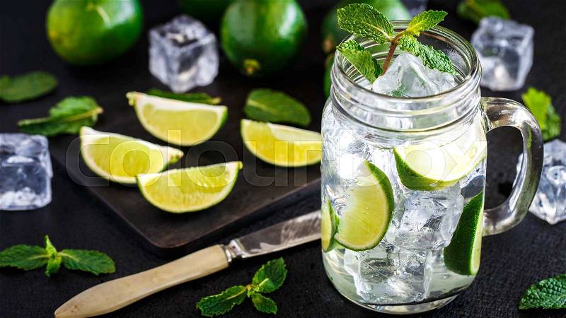Cold drink with lime and mint in a glass, stock photo