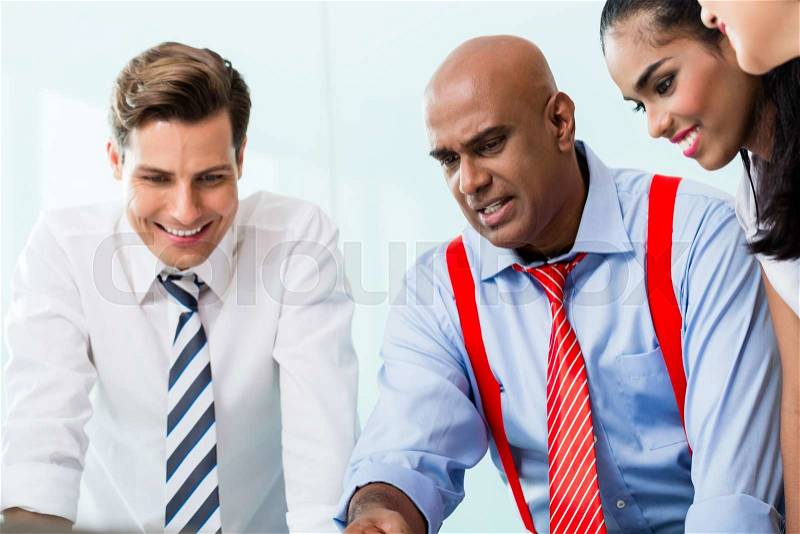 Business team with Indian CEO in meeting, stock photo