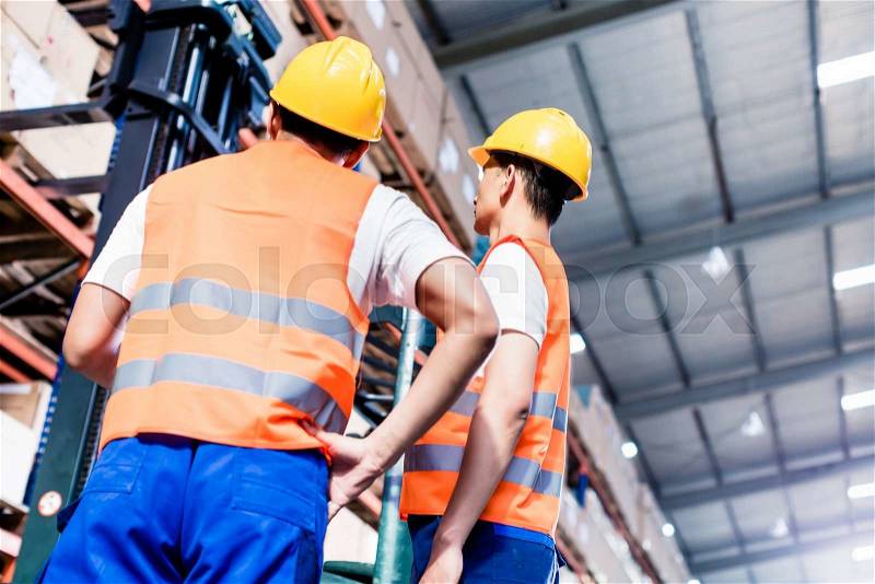 Worker team taking inventory in logistics warehouse, stock photo