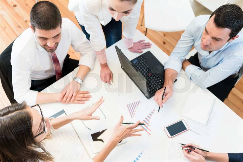 Business women and men in meeting finding ideas, stock photo
