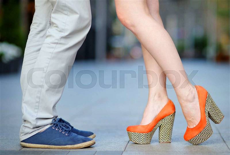 Closeup photo of male and female legs during a date, stock photo