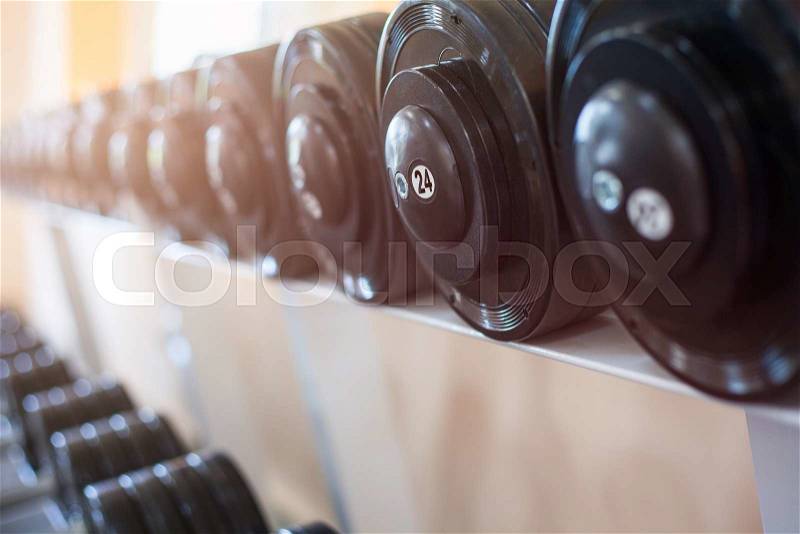Sports dumbbells in modern sports club. Weight Training Equipment, stock photo