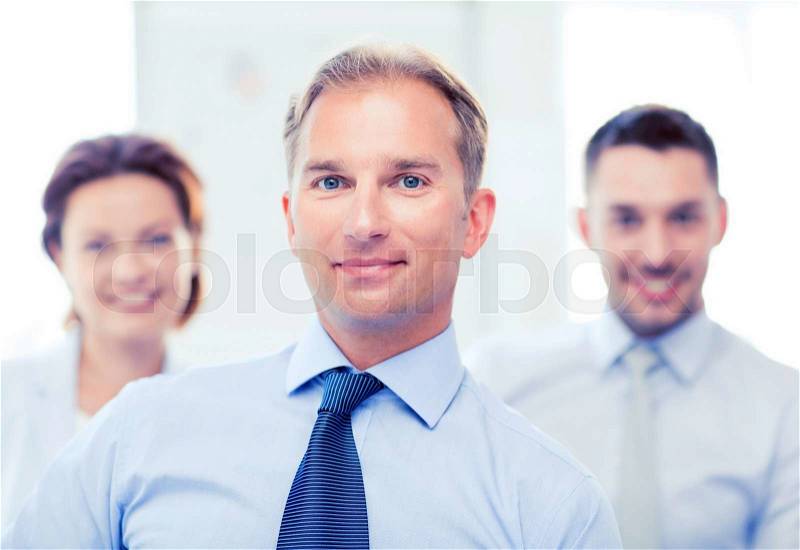 Picture of smiling handsome businessman in office, stock photo