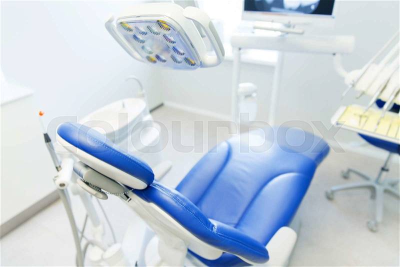 Dentistry, medicine, medical equipment and stomatology concept - interior of new modern dental clinic office with chair, stock photo