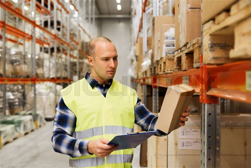 Wholesale, logistic, people and export concept - man with clipboard and box in reflective safety vest at warehouse, stock photo