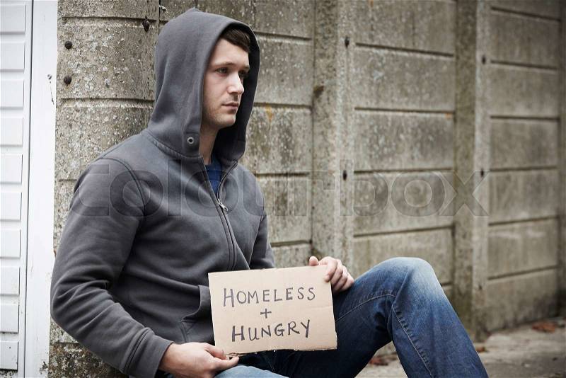 Homeless Young Man Begging On The Street, stock photo
