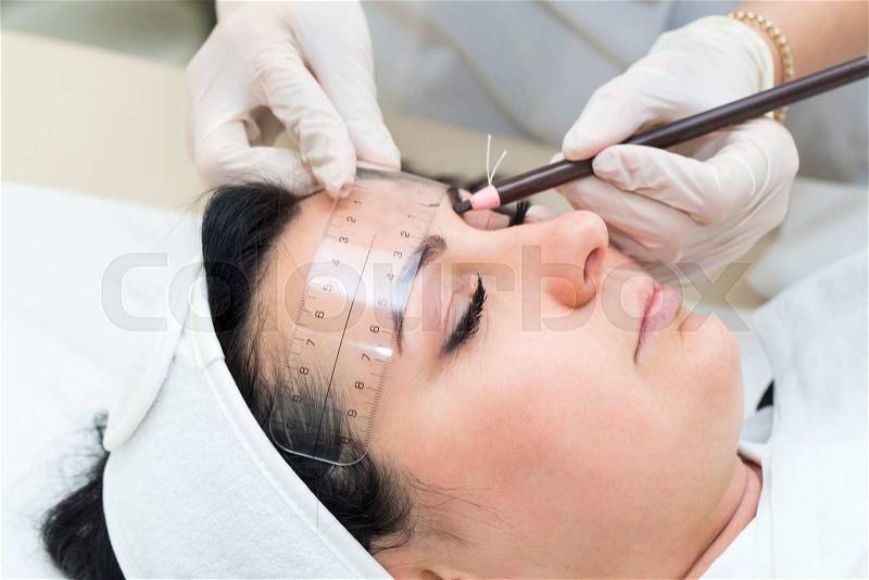 Mikrobleyding eyebrows workflow in a beauty salon, stock photo