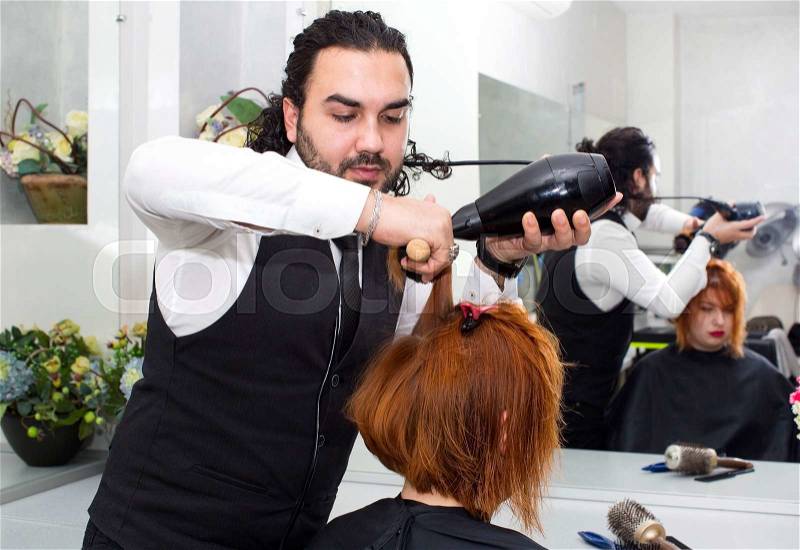 Hairdresser makes hair woman in a beauty salon, stock photo