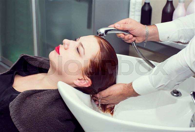 Hairdresser makes hair woman in a beauty salon, stock photo