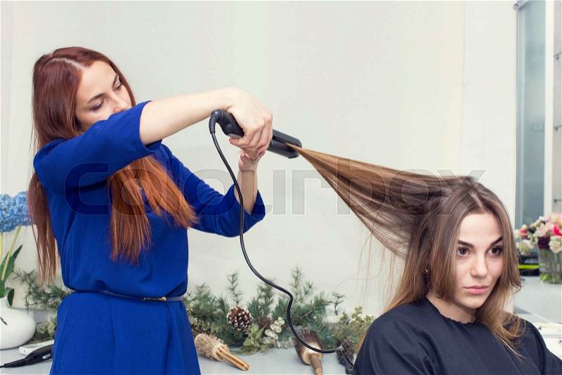 Woman in a beauty salon doing hair, stock photo