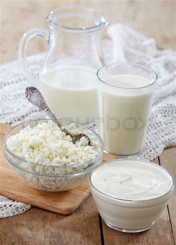 Fresh milk products on old wooden table, stock photo