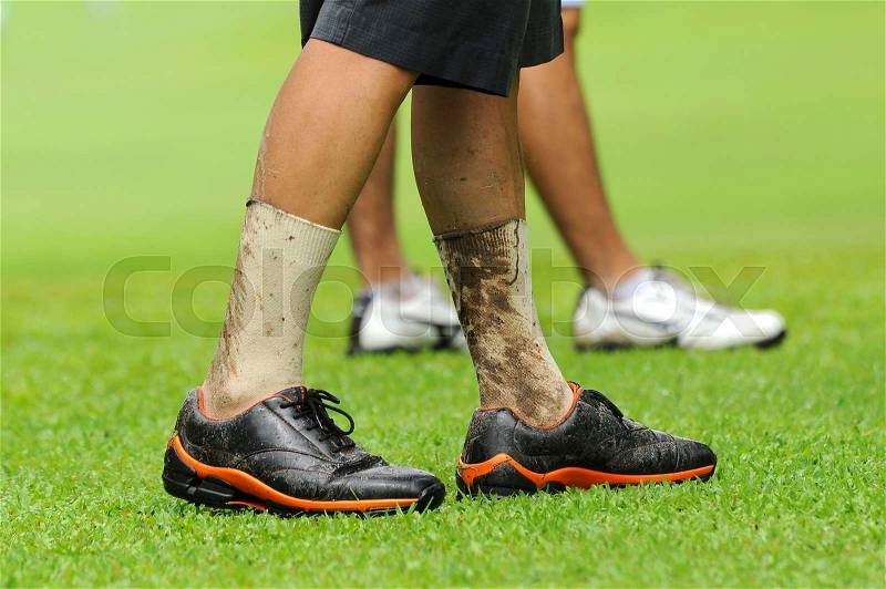 Dirty legs of golf player in raining game, stock photo
