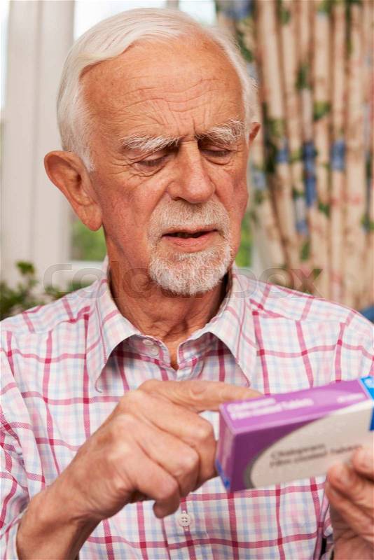 Senior Man Reading Instructions On Medication, stock photo