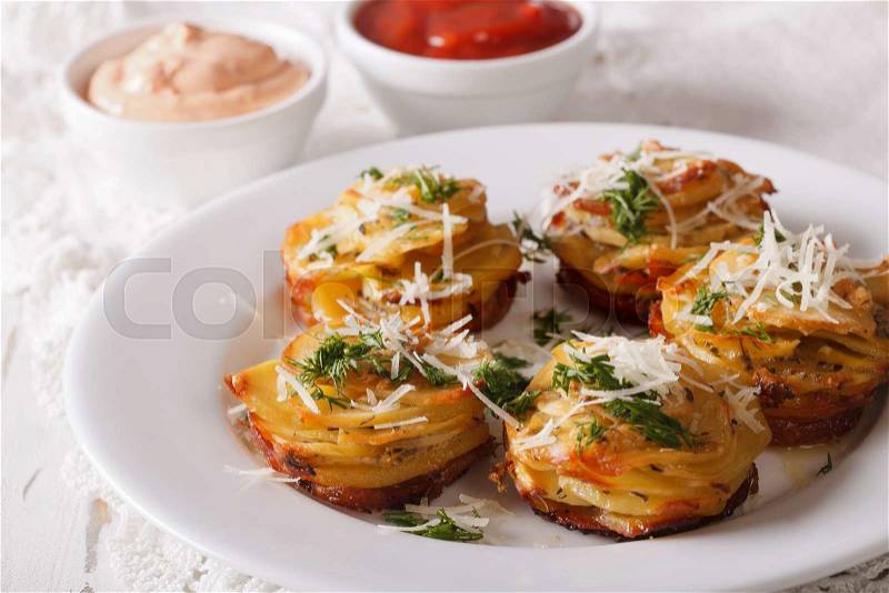 Sliced baked potato with cheese and sauce close-up on the table. horizontal , stock photo