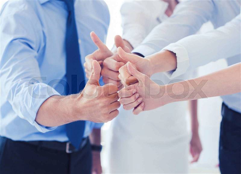 Success and winning concept - happy business team showing thumbs up in office, stock photo