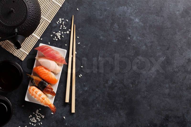 Set of sushi and green tea on stone table. Top view with copy space, stock photo