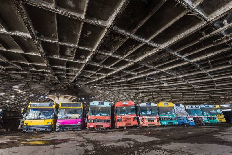 Colored buses in abandoned bus depot, stock photo