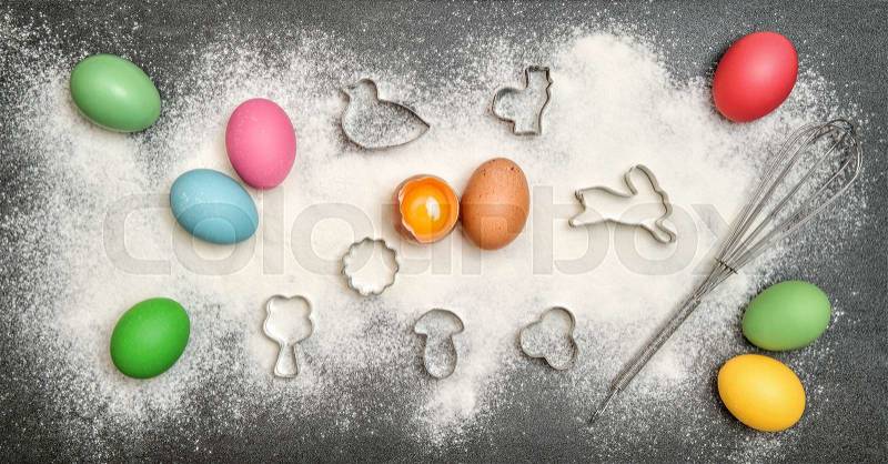 Cookies ingredient and colored easter eggs. Food background, stock photo
