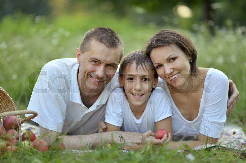Happy family with a basket of fruits, stock photo