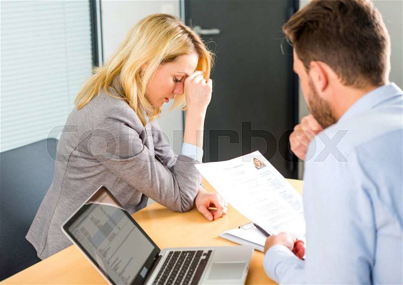 View of a Young attractive woman upset during job interview, stock photo