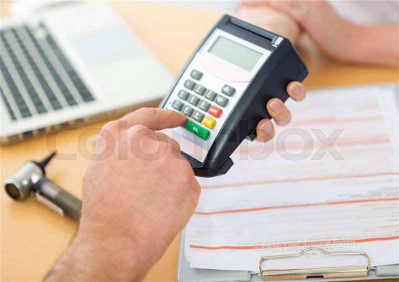 Close up view of somebody paying doctor by credit card, stock photo
