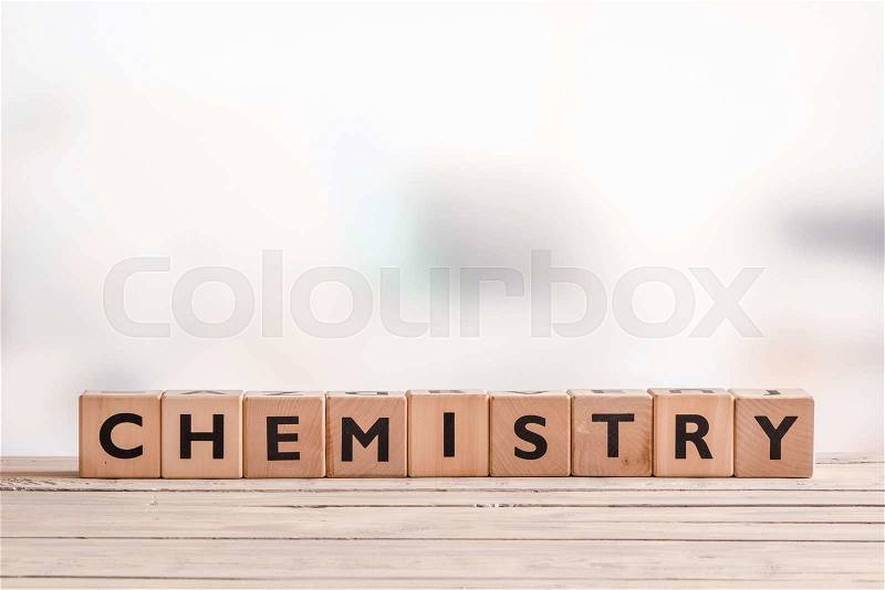 Chemistry sign on a wooden table in a room, stock photo