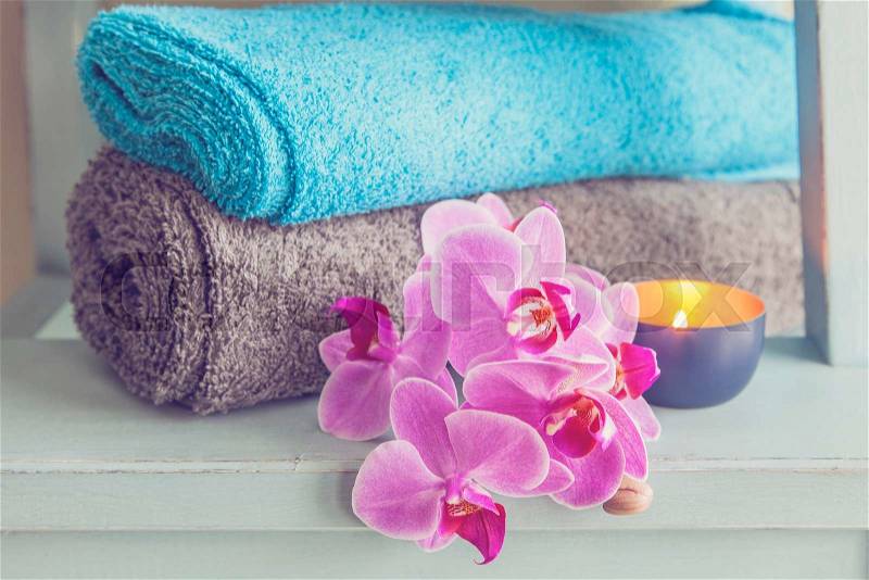 Wellness or spa concept still life with towels, candle and orchid. , stock photo
