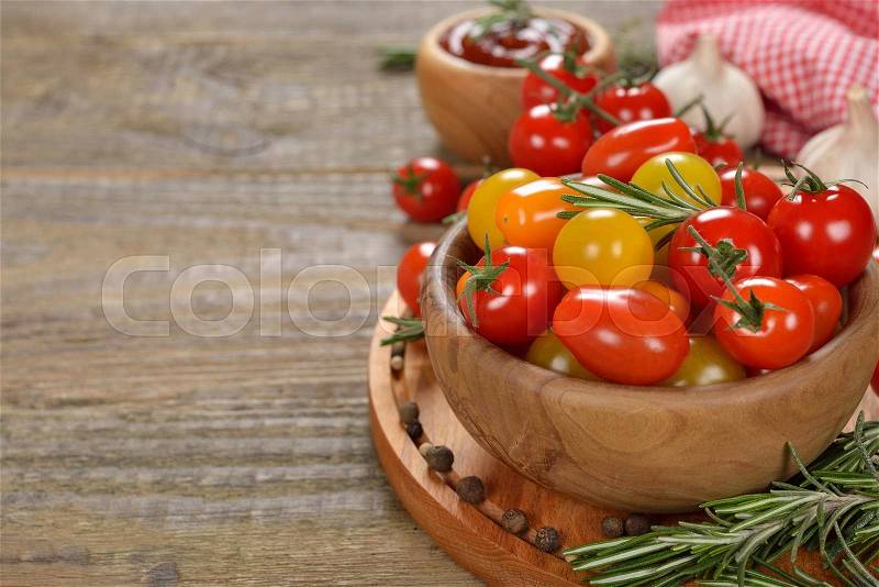 Various cherry tomatoes on a wooden background, stock photo
