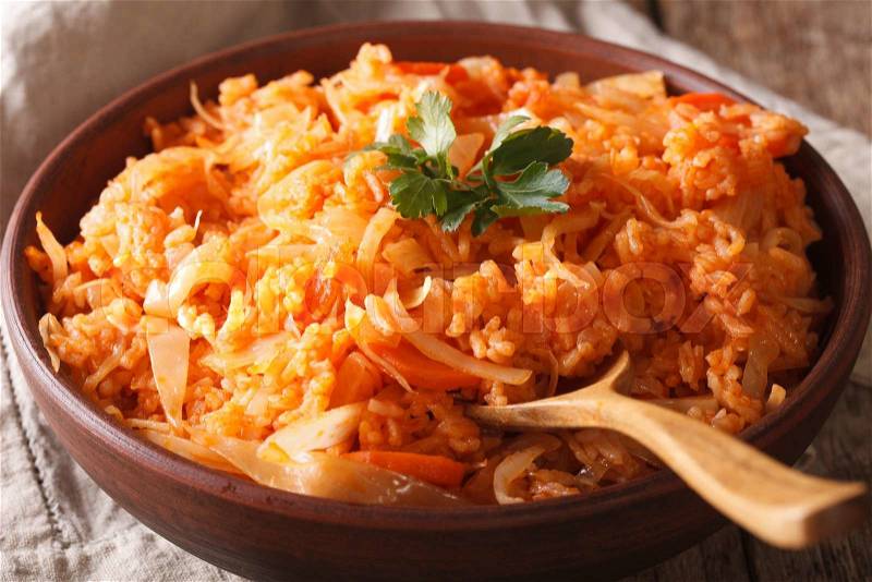 Rice stew with cabbage and carrots in a bowl close-up. horizontal , stock photo