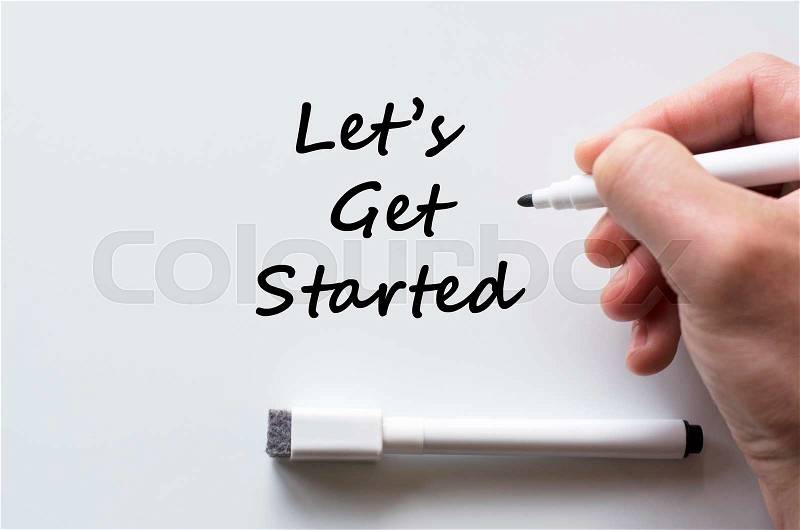 Human hand writing let\'s get started on whiteboard, stock photo