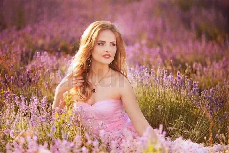 Beautiful young woman in the lavender fields. Pink skirt , a good mood . Provence , stock photo