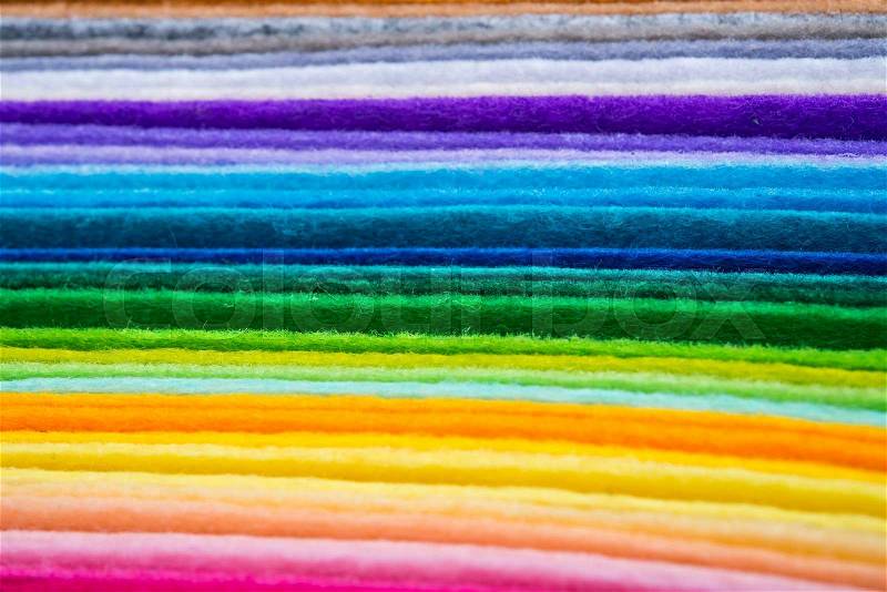Felt fabric sheets in various colors piled up in a stack, stock photo