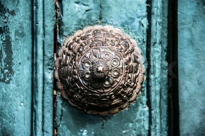 Copper door decoration on the old door of the temple in Cuzco, Peru, stock photo