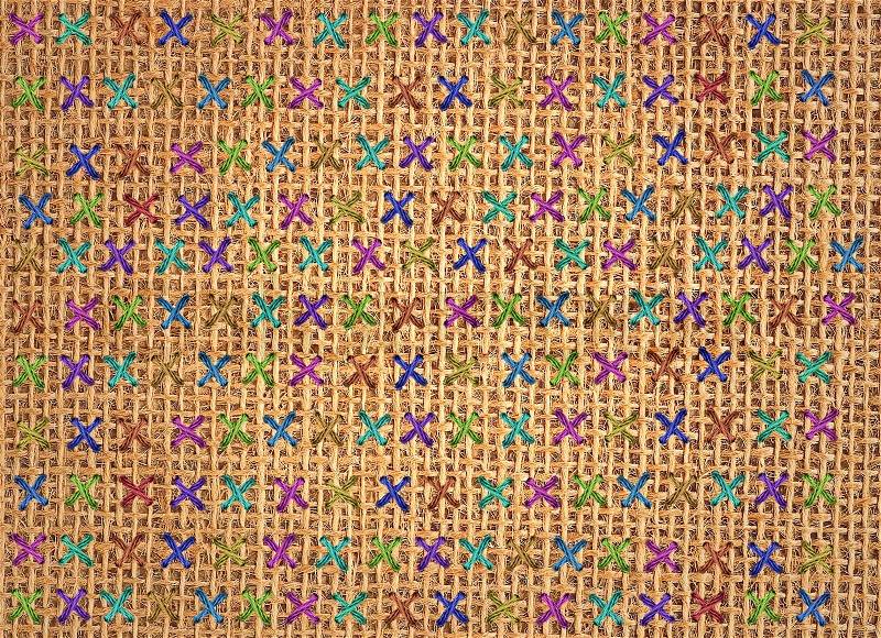 Close up of colorful cross stitch detail on designer cushion, stock photo
