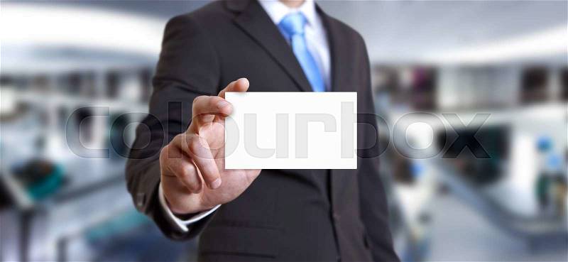 Businessman holding white business card in his hand, stock photo