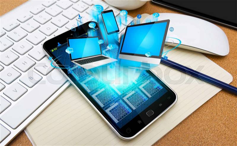 Modern mobile phone in office connecting tech devices together, stock photo