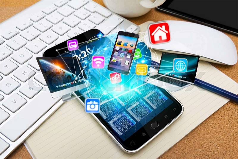 Modern mobile phone in office connecting tech devices together, stock photo