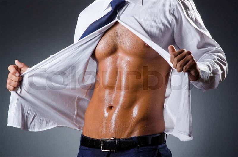 Ripped young man in studio concept, stock photo