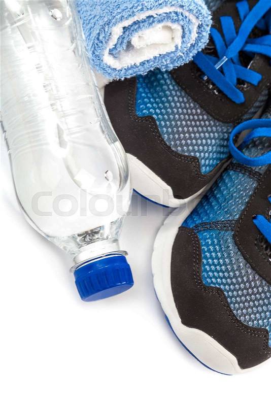 Sport shoes, towels and water bottle isolated on a white background, stock photo