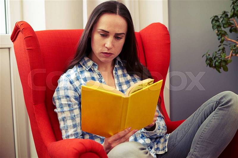 Woman resting on the chair with book, stock photo