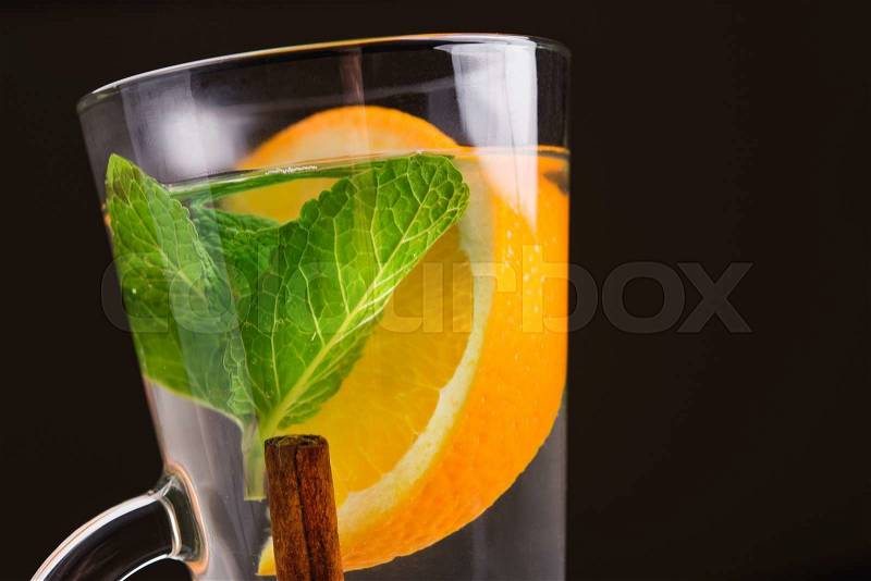 Cup of tea with cinnamon, mint and orange, stock photo