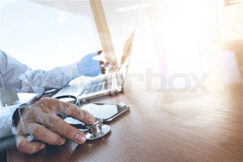 Doctor hand working with laptop computer in medical workspace office as concept, stock photo