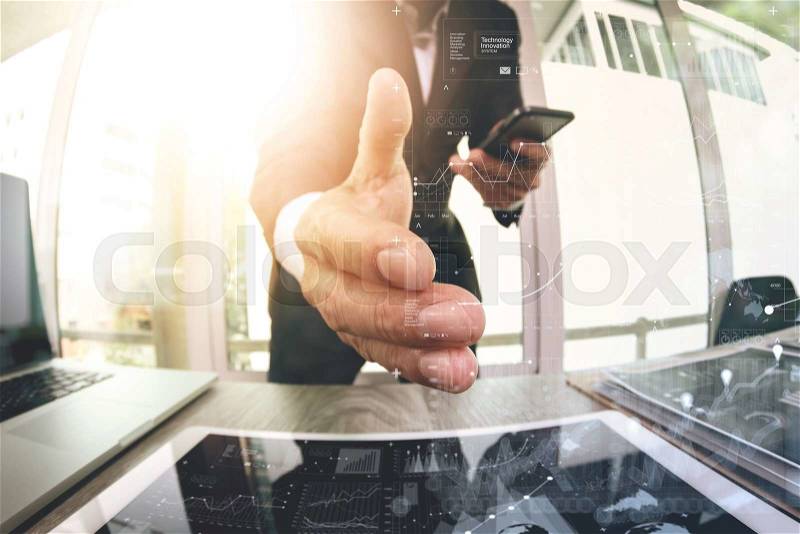 Businessman extending hand to shake with digital business strategy diagram in his office as concept, stock photo