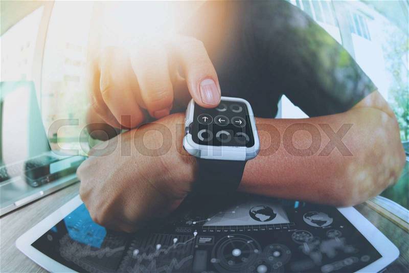 Website designer working with smart watch and digital tablet and digital design diagram on wooden desk as concept , stock photo