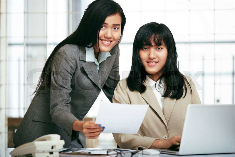 Office staffs working and typing work in laptop, stock photo