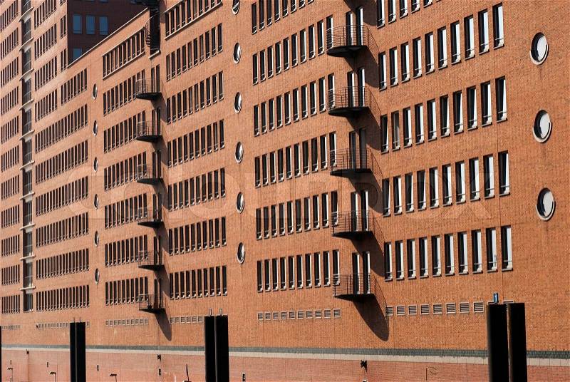 Modern brick wall facade from Hamburhg harbour. Office building close to canal, stock photo