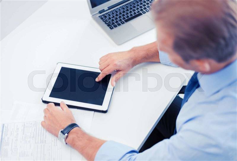 Business, office, school and education concept - businessman with tablet pc in office, stock photo