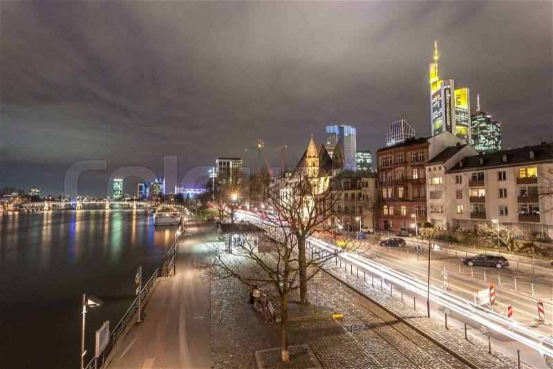 Riverbank and Frankfurt Main downtown illuminated at night. Frankfurt, Germany, stock photo