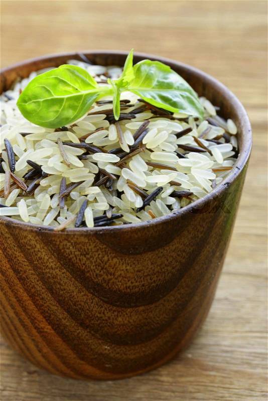 Mix of wild black and white rice in a wooden bowl, stock photo
